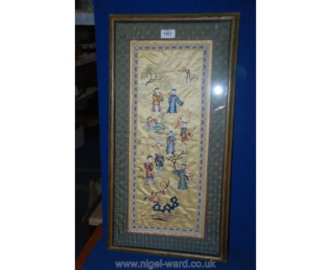 A framed Oriental Needlework panel depicting Figures and foliage 25'' x 12"