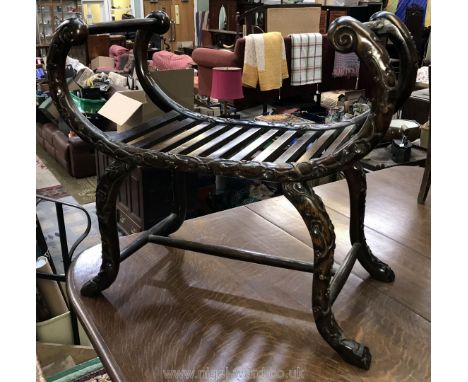 A Chinese Huanghuali window seat second half of the 19th century of curule form, carved with trailing prunus and with slatted