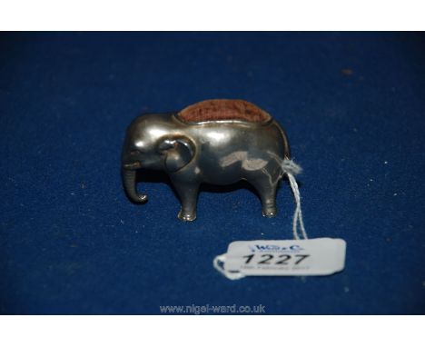 A miniature metal Pin Cushion in the shape of a baby elephant, late 19th c., with original velvet pad, 2" long