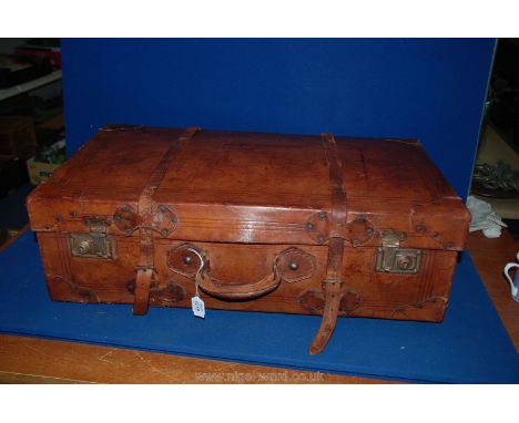 A vintage leather belted Suitcase, 27'' x 16''.