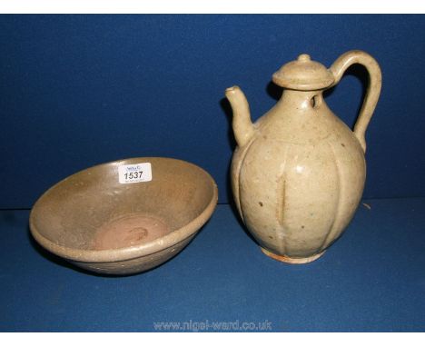 A green glaze celadon bowl with raised flowers to the interior and an unusual cream celadon ewer- both heavily potted probabl