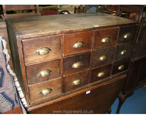 A circa 1920's Oak table top Chest of twelve index card drawers comprising four flights of three drawers with Oak linings and
