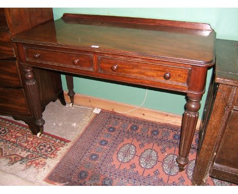 A good William IV Mahogany Writing Table having upstand back to the rounded corner moulded edge rectangular top, pair of Maho