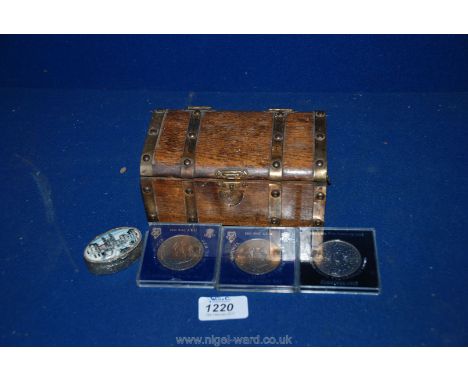 A small trunk shaped Box containing three commemorative Coins and small pill box