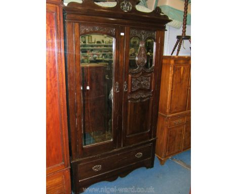 An Art Nouveau stained Walnut double doored Wardrobe having pierced, fret-cut pediment on moulded cornice, over full length a