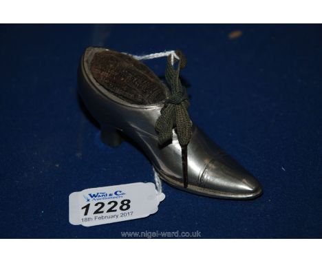 A metal Pin Cushion, early 20th c. in the shape of a ladies shoe