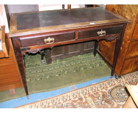 An Edwardian Mahogany Writing Table by Trapnell & Gane of Queen Street, Cardiff, the moulded edge rectangular top having brow