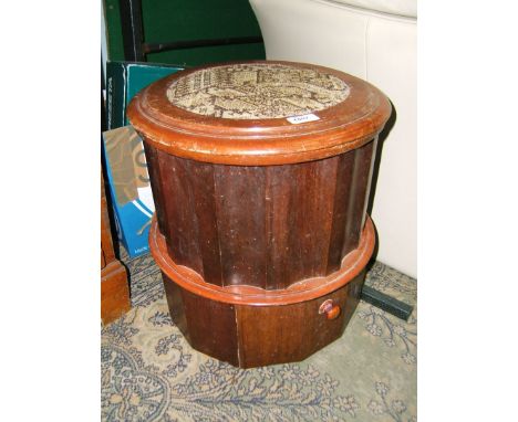 A late 19th c. Mahogany cylinder Commode, circular moulded edge top with tapestry insert, on shaped column with lidded cerami