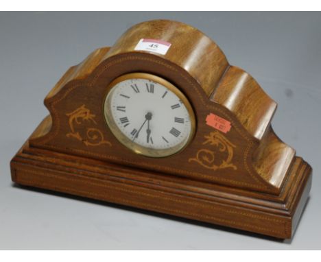 An Edwardian mahogany and satin wood inlaid cased mantel clock having an enamel dial with Roman numerals and French cylinder 