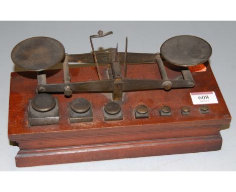 *A set of late Victorian brass postal scales, on a mahogany plinth, with matching weights, stamped Radcliffe Patent 