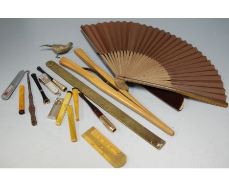 A small collection of miscellaneous items, to include; pocket cigar cutter, cheroot holders, button hook, glove stretchers et