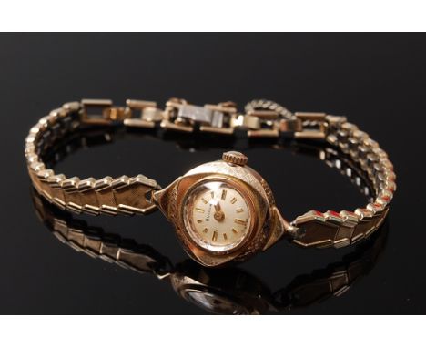 A ladies Bulova 9ct gold cased wrist watch having a manual wind movement, back cover stamped and numbered 97317, 1.8cm, with 