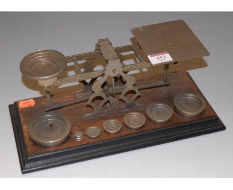 *A set of Victorian steel post office scales and weights, on walnut and ebonised plinth