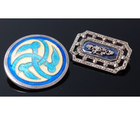 A silver and enamel Manxman style disc brooch, together with a white metal and marcasite set brooch (2)