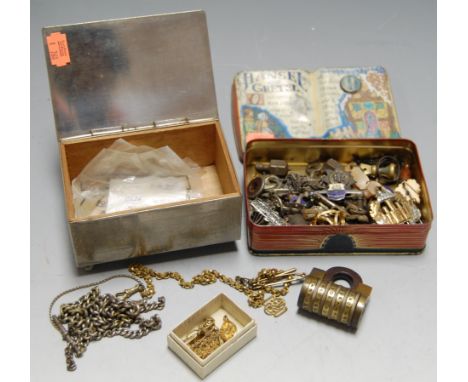 A reproduction biscuit tin, lithograph printed with verse from Hansel & Gretel, contents to include military cap badges, bar 