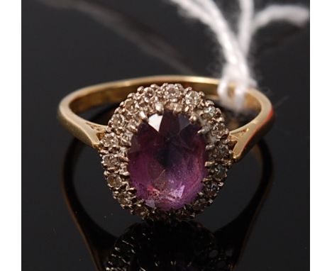 An 18ct gold oval cut amethyst and diamond point set dress ring, 4g, size P