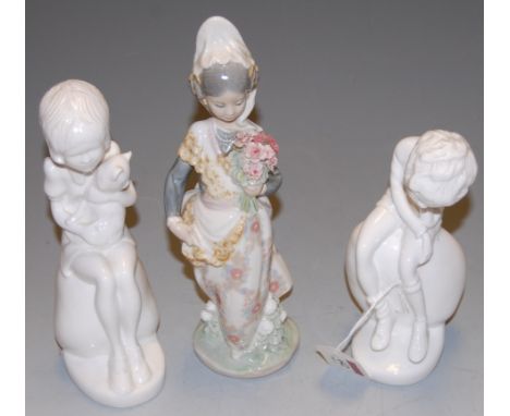 A Lladro porcelain figure modelled as a bridesmaid, printed mark verso, height 25cm, together with two Spode blanc de chine f