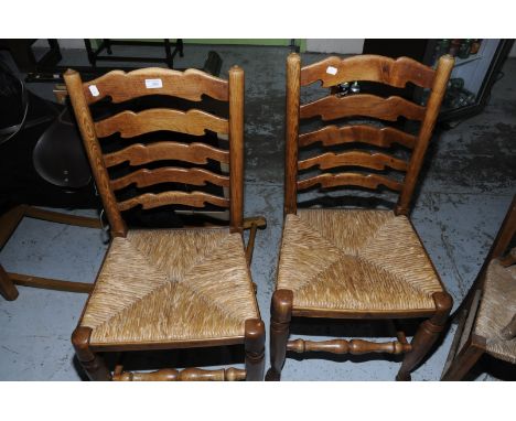 Set of four oak ladder back dining chairs with rush seats 