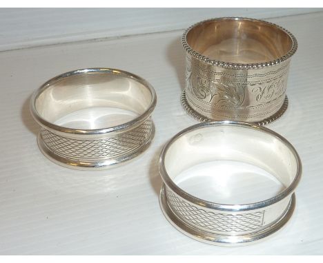 Pair of silver hallmarked napkin rings with engine turned engraving and one other