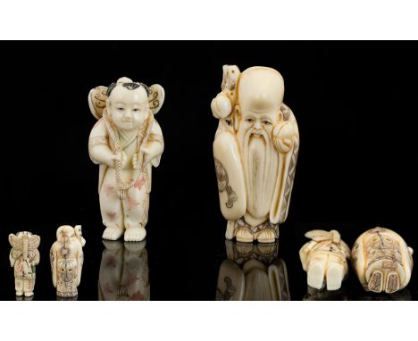 A Pair Of Carved Netsuke The first in the form of a sage in traditional robes, the second in the form of a young boy with kit