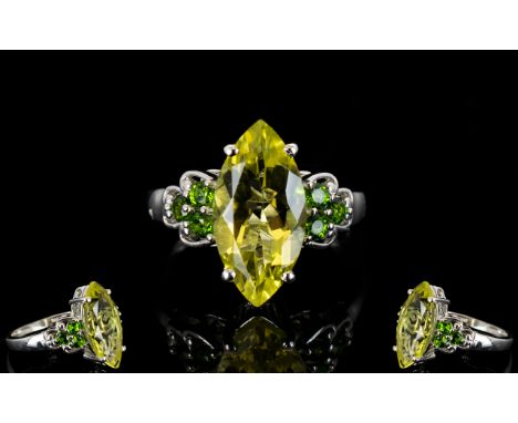 Green Gold Quartz and Russian Diopside Ring, a 5.25ct marquise cut green gold quartz, flanked by three round cut Russian diop