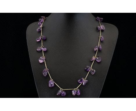 A Vintage Amethyst Necklace Long pewter tone necklace set with multiple, organic form polished amethyst stones between elonga