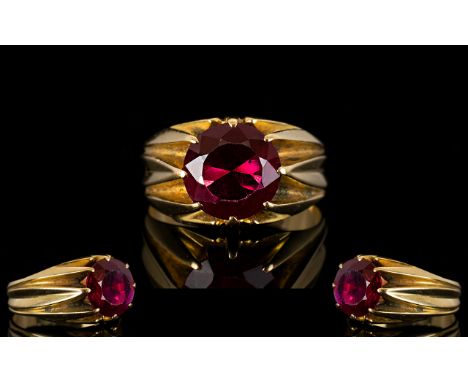 An Unmarked 18ct Gold And Ruby Ring Mounted with a blood red ruby coloured gemstone, est weight, 3.25cts. Ring size R