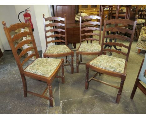 A SET OF FOUR OAK LADDER BACK DINING CHAIRS