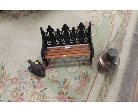 A CAST IRON MINIATURE GARDEN BENCH, TOGETHER WITH A VINTAGE FLAT IRON AND AN OIL LAMP (3) 