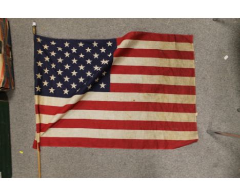 A VINTAGE AMERICAN FLAG - H 59 CM BY W 87 CM,  ON POLE