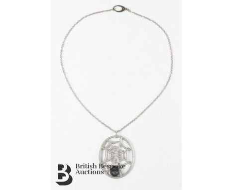 Brilliant Stars black cats eye sapphire and diamond spider web pendant. The cat's eye sapphire measures 14 x 12 mm, the penda