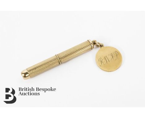 9ct gold toothpick, having engine-turned decoration with a small medallion attached to the suspension loop, 8.37 gms.&nbsp;