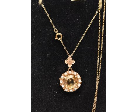 A 9CT GOLD CITRINE AND SEED PEARL PENDANT NECKLACE, the pendant of a circular form, set to the centre with a circular cut cit
