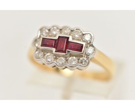 AN 18CT GOLD RUBY AND DIAMOND RING, three baguette cut rubies, bezel set in white gold, within a surround of round brilliant 