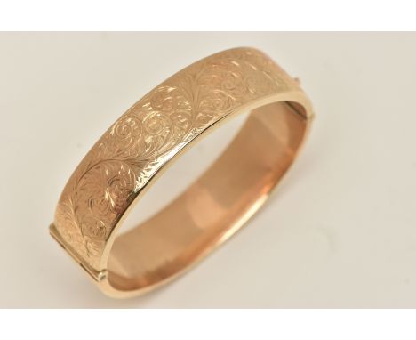 A 9CT GOLD HINGED BANGLE, wide floral detailed hinged bangle, approximate width 16.4mm, fitted with a push piece integrated c