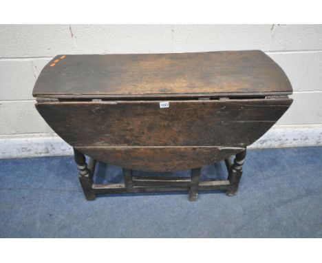 A GEORGIAN OAK GATE LEG, with a single drop leaf, raised on block and turned legs, width 97cm x depth 37cm x height 65cm (con