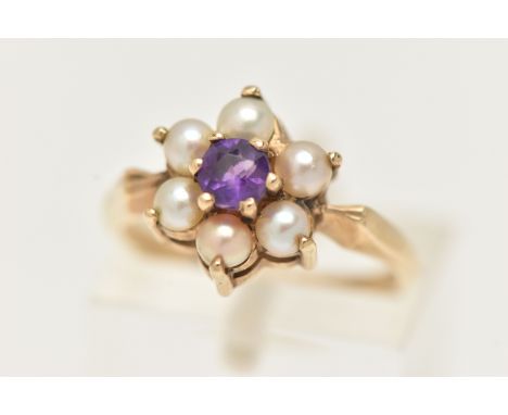 A YELLOW METAL AMETHYST AND SPLIT PEARL CLUSTER RING, of a flower shape set to the centre with a circular cut amethyst, claw 