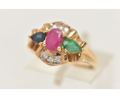 A MODERN 9CT YELLOW GOLD GEM SET AND DIAMOND DRESS RING, set with a central oval glass filled ruby, a pear shape emerald, a p