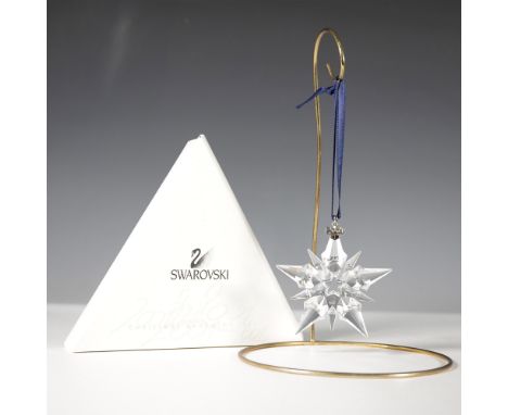The Swarovski 2001 Christmas Ornament is an exquisite faceted crystal snowflake, showcasing intricate craftsmanship and brill