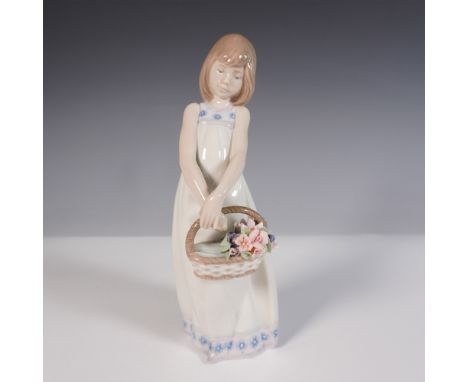 This delicately crafted piece features a young girl in a flowing white dress with blue floral accents, gracefully holding a w