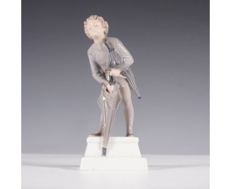 A finely sculpted Royal Copenhagen porcelain figurine depicting a young boy struggling to close an umbrella in the wind. The 