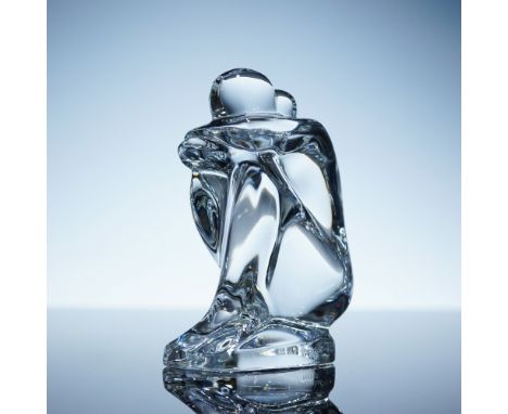 Clear crystal sculpture by Robert Rigot for Baccarat, depicting a woman seated with knees drawn up and head resting on her ar