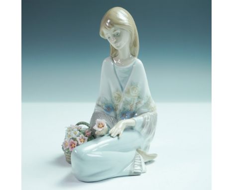 Lladro porcelain figurine Flower Song 1007607 is a limited-edition piece that portrays a serene young woman seated with a bas