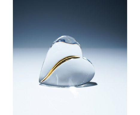 Elegant Baccarat crystal heart paperweight featuring a sleek curved design with a striking gold accent. Crafted in France, th
