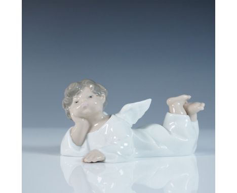 A charming Lladro porcelain figurine titled Reclining Angel, model number 1004541, sculpted by Fulgencio Garcia. This exquisi