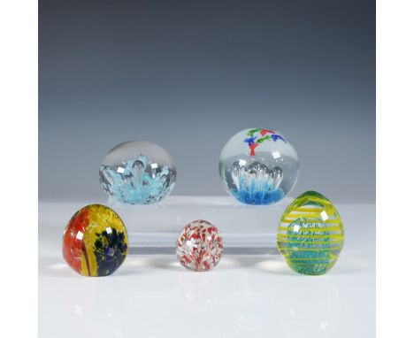 A striking collection of five art glass paperweights, each showcasing unique designs and vibrant color combinations. This set