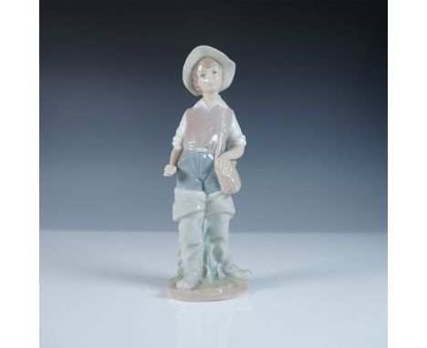 This Lladro figurine, titled Going Fishing (#1004809), portrays a young boy dressed in classic fishing attire, complete with 