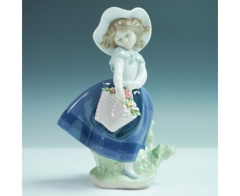 Lladro porcelain figurine Pretty Pickins 5222 captures a young girl in a flowing blue dress and bonnet, delicately holding a 