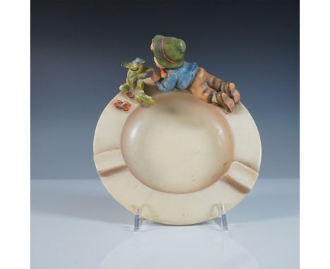 This Goebel Hummel ashtray, featuring a boy interacting with a bird, captures the signature charm and craftsmanship of Hummel