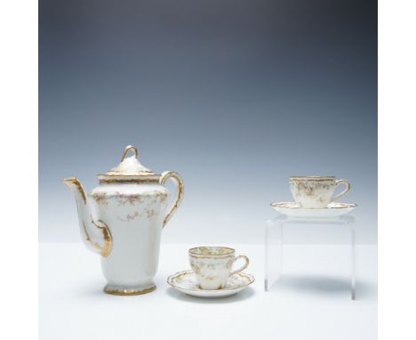 A delicate Theodore Haviland Limoges porcelain tea set, adorned with hand-painted floral motifs in soft pink and green hues, 